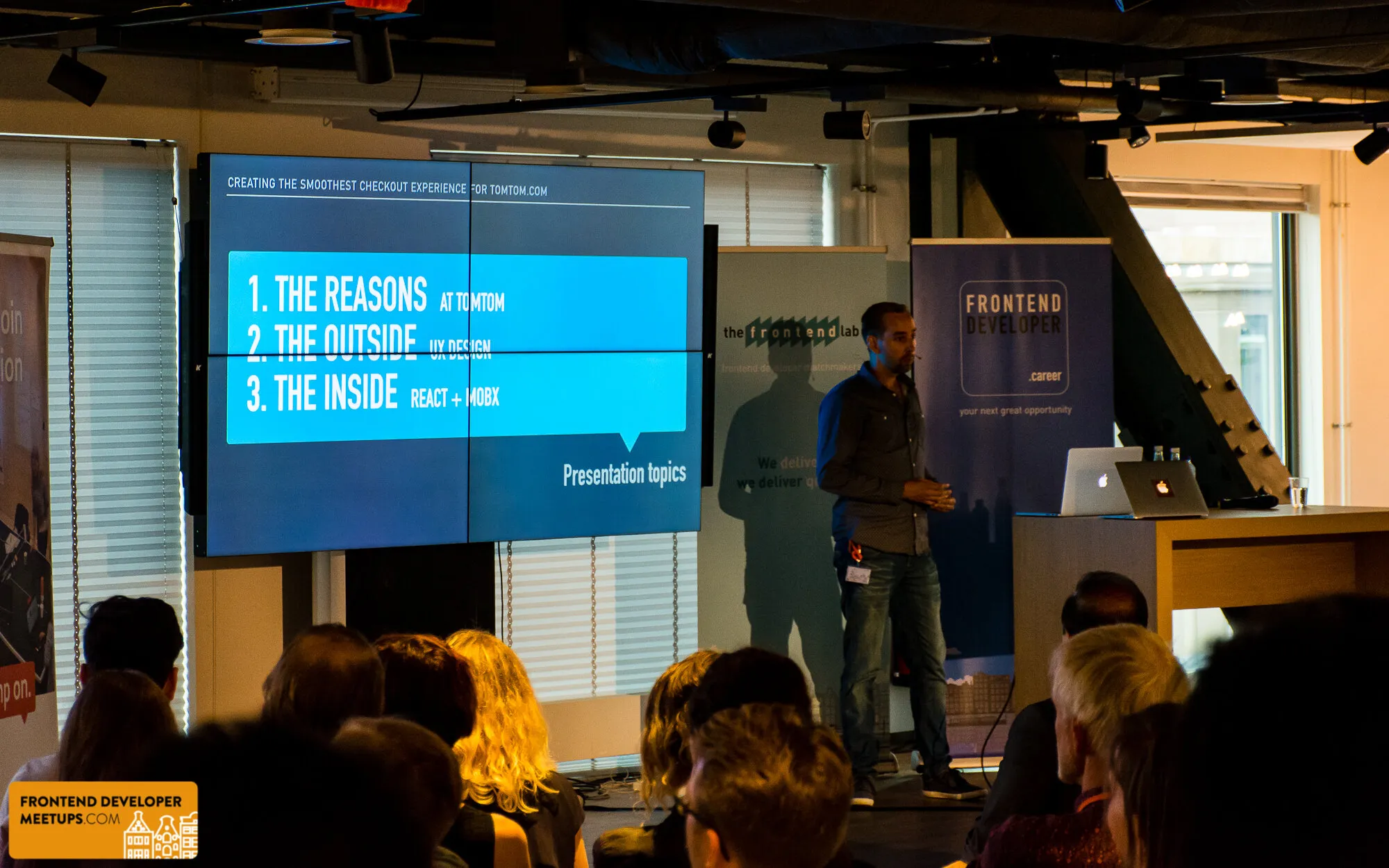 The Presentation topics slide on a video wall, the reasons, the outside and the inside, with the speaker on stage at ING